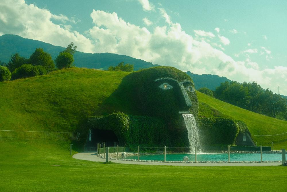 Artistic landscape with face-shaped hill and waterfall